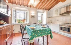 a kitchen with a table with a green table cloth at Corte Pasquini in San Ginese