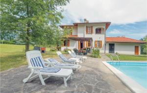 a group of chairs sitting next to a swimming pool at Villa Il Colle in Molezzano