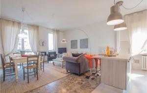 a living room with a kitchen and a living room with a couch at Casa Catullo in Desenzano del Garda