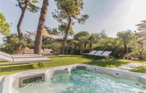 a hot tub in a yard with a park at Casa Catullo in Desenzano del Garda