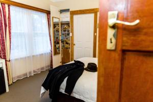 a room with a bed with a hat on it at Ashdowns of Dover in Dover