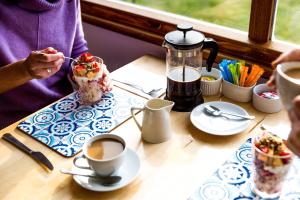 a person sitting at a table with a dessert and coffee at Ashdowns of Dover in Dover