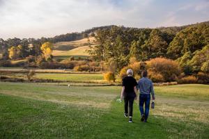 two people walking down a grassy field at Ashdowns of Dover in Dover