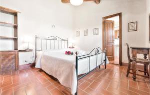 a bedroom with a large bed and a fireplace at Flaminia - Podere Moricci in Montaione