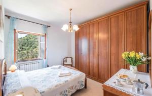 a bedroom with a bed and a table and a window at Casa Rosmarino in Chiesanuova