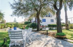 a table and chairs in a yard with trees at Villa Marina in Granelli