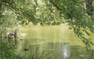 a man is standing in the middle of a river at Gorgeous Home In Tarzo With Sauna in Tarzo