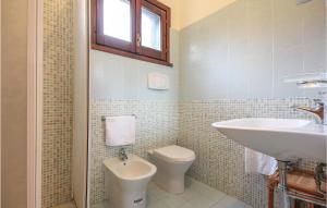 a bathroom with a toilet and a sink at Awesome Apartment In Costa Rei -Ca- With Wifi in Monte Nai +7 photos