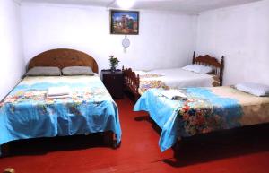 Rúm í herbergi á Cuzco Central Hostel
