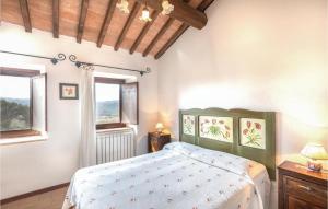 a bedroom with a bed and two windows at Apartment Todi PG 27 in Canonica