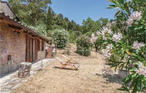 a wooden bench in a yard with pink flowers at Lovely Home In San Vito Di Narni Tr in San Vito +14 photos