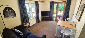 a living room with a couch and a table at Margaret River Guest House in Margaret River Town