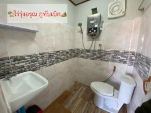 a bathroom with a toilet and a sink at ไร่รุ่งอรุณ ภูทับเบิก in Ban Maeo Thap Boek