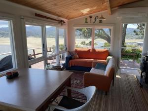 a living room with a couch and a table at Tairua Treasure on Mount Paku in Tairua