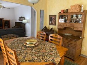 a dining room with a table and a table and chairs at River Falls Lodging -Black Hills, South Dakota in Hot Springs