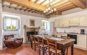 a kitchen with a table and chairs and a fireplace at Palazzo 1p in Polvano