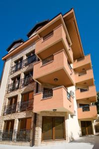 a building with balconies on the side of it at Apartments Ivan in Petrovac na Moru