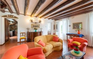 a living room with orange chairs and a couch at Ballo in Montebelluna