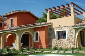 a house with a pool in front of it at I Lentischi in Villasimius