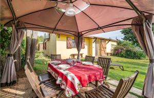 a table and chairs under an umbrella in a yard at Casa Leo in Casa SantʼEugenia