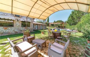 a patio with chairs and tables under an umbrella at Apartment Todi PG 28 in Canonica