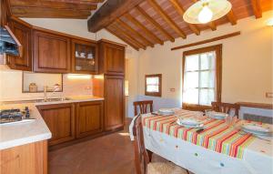 a kitchen with a table with a striped table cloth at La Casetta in Montepulciano