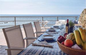 una mesa con un bol de fruta y vistas al océano en Gorgeous Home In Tarquinia vt With Wifi, en Tarquinia