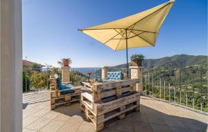 a patio with a table and an umbrella at Lovely Home In Moneglia With Wifi in Moneglia