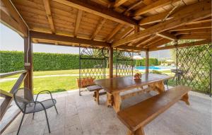 a wooden picnic table and bench on a patio at Macchia Rossa in Caprino Veronese