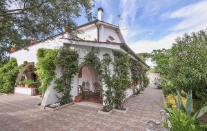 a white house with ivy growing around it at Gorgeous Home In Ardea With House A Panoramic View in Ardea