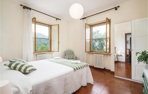 a bedroom with a bed and two windows at Amazing Home In Spoleto With Wifi in Bazzano Inferiore