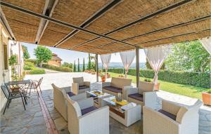 an outdoor patio with white chairs and a table at La Veranda in San Giustino Valdarno