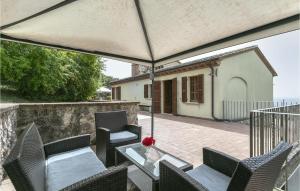 a patio with chairs and a table with an umbrella at Mandrie in Guardea