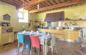 a kitchen with a table with colorful chairs in it at Podere Case Sparse in Citerna