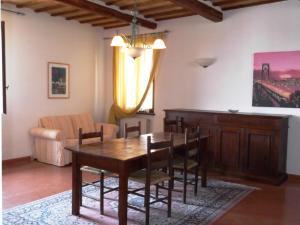 a dining room with a table and a couch at Palazzo Nanni in Montefalco