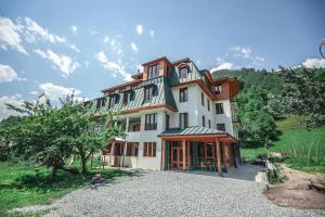 a large house on top of a hill at Latour Mestia in Mestia