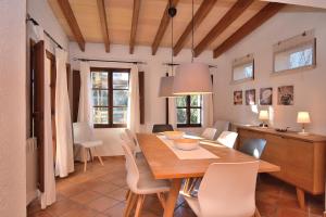 a dining room with a wooden table and chairs at Finca Siscelis 063 by Mallorca Charme in Santa Maria del Camí