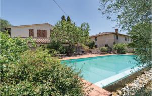 a swimming pool in front of a house at Borgo Basso in Barberino di Val dʼElsa
