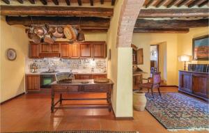 a kitchen with wooden cabinets and a table at Borgo Basso in Barberino di Val dʼElsa