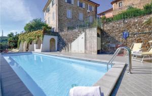 a large swimming pool in front of a building at Riccio in Mommio