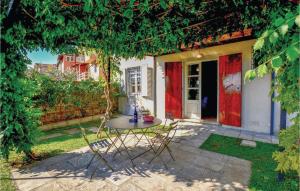 a patio with a table and chairs under a tree at Riccio in Piano di Mommio +13 photos