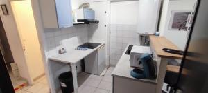 a small kitchen with a counter and a sink at Appartement au cœur de ville à 2 mins de la gare in Agen +35 photos