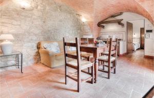 a dining room with a table and a stone wall at Scipione - Podere Moricci in Montaione