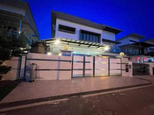 a white building with a gate in front of it at HomeAway Paradise @ Taman Mutiara Bestari in Johor Bahru