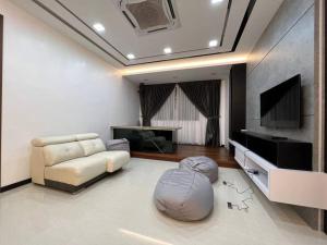 a living room with a couch and a flat screen tv at HomeAway Paradise @ Taman Mutiara Bestari in Johor Bahru