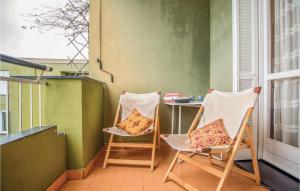 two chairs and a table on a balcony at Casa Charlie in Varazze +14 photos