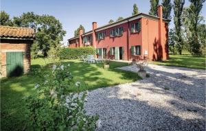 a large red building with a yard in front of it at 2 Bedroom Awesome Home In Taglio Di Po Ro in Porto Viro