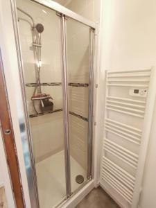 a shower with a glass door in a bathroom at F2 - 30m2 Face à la mer in Luc-sur-Mer