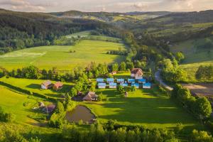 an aerial view of a farm in the hills at Domki Żaklin in Polańczyk