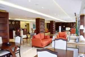 a lobby with orange and white furniture in a store at فندق السلطنة جازان -Alsltanah Jazan Hotel in Jazan